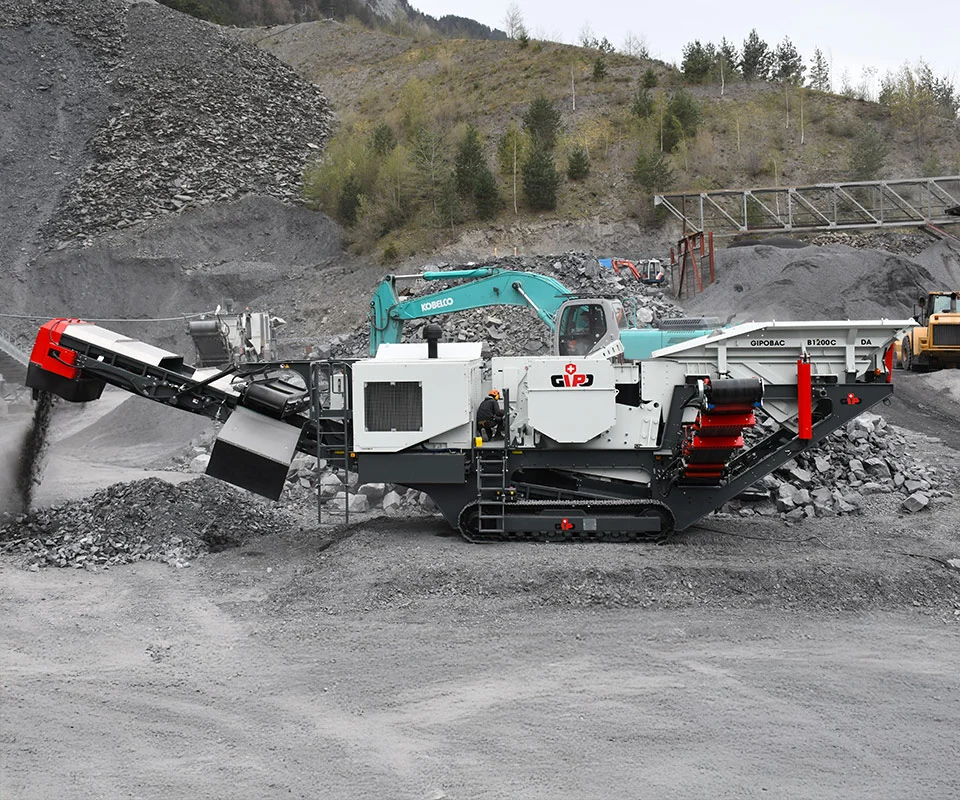 Gipo B1270 Mobile jaw crushing plant in a quarry, excavator feeding the hopper; conveyors stockpiling crushed rock.