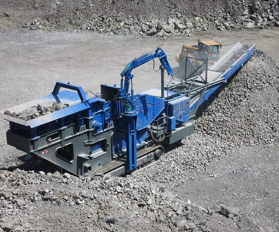 Gipo B14100 Mobile jaw crushing plant in a quarry, excavator feeding the hopper; conveyors stockpiling crushed rock.