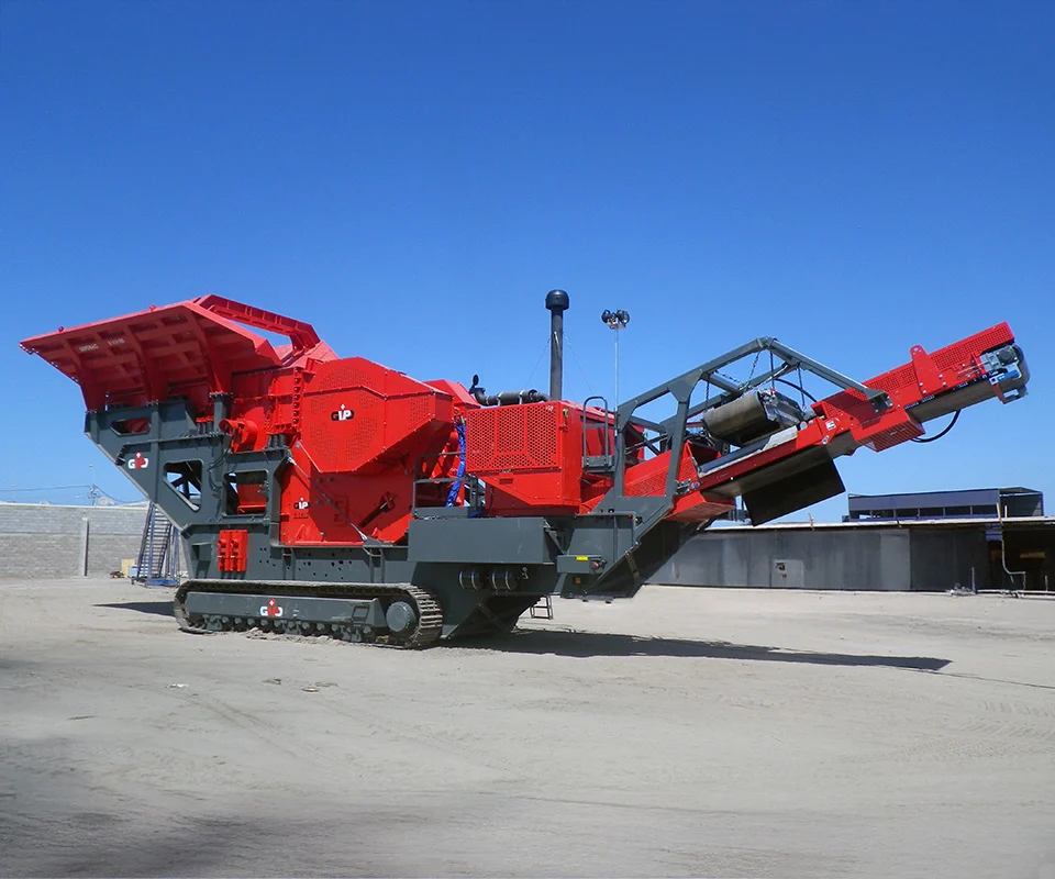 Gipo B14100 Mobile jaw crushing plant working against the quarry face; side conveyor discharging aggregate.