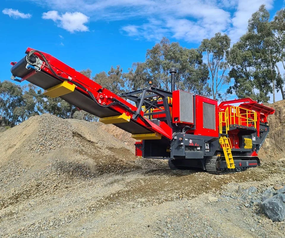 Gipo B1470 Mobile jaw crushing plant in a quarry, excavator feeding the hopper; conveyors stockpiling crushed rock.