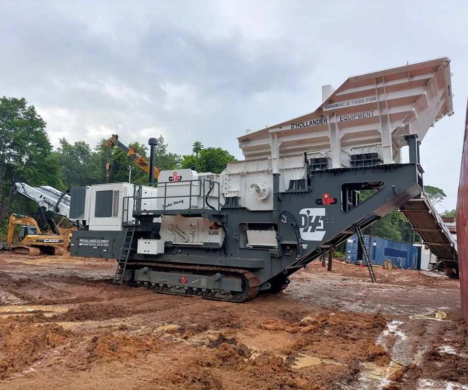 Gipo B1490 Mobile jaw crushing plant in a quarry, excavator feeding the hopper; conveyors stockpiling crushed rock.